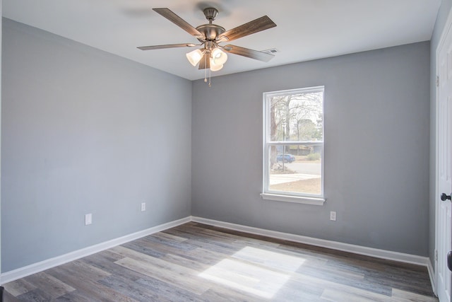 unfurnished room featuring visible vents, baseboards, ceiling fan, and wood finished floors