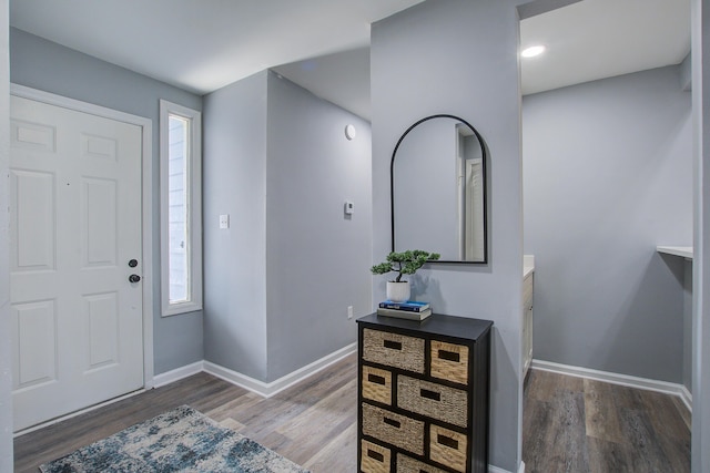 foyer featuring wood finished floors and baseboards