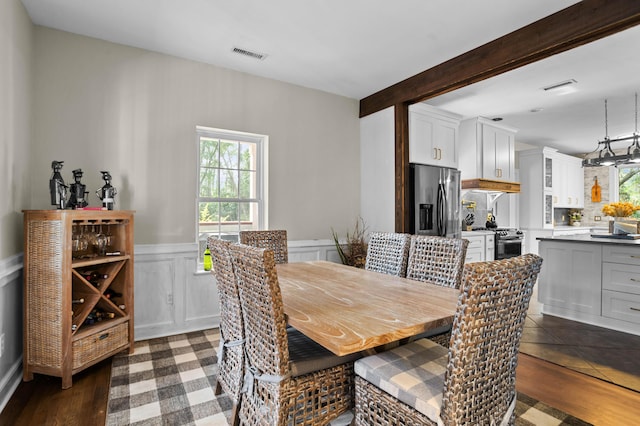 dining space featuring beam ceiling