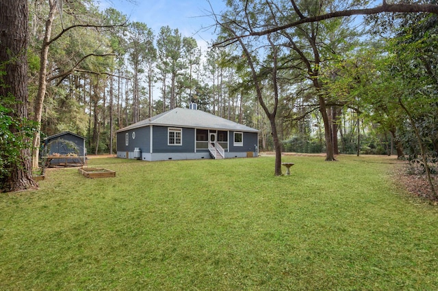 rear view of property with a sunroom and a lawn