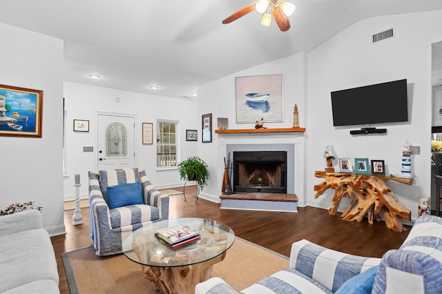 living room with lofted ceiling, hardwood / wood-style floors, a fireplace, and ceiling fan