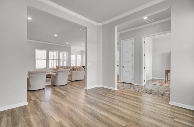 unfurnished living room with ornamental molding and light wood-type flooring