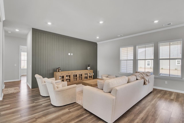 living room featuring crown molding and hardwood / wood-style floors