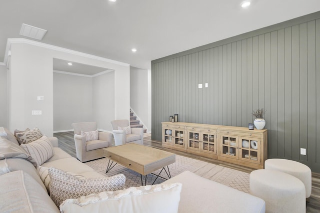 living room featuring hardwood / wood-style flooring and ornamental molding