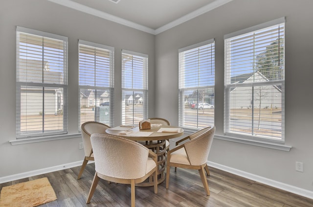 dining space featuring ornamental molding and hardwood / wood-style floors