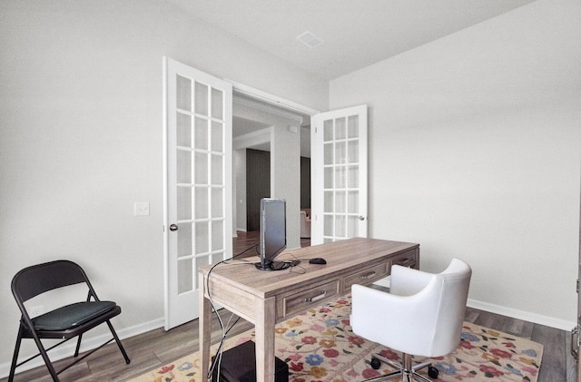 home office featuring hardwood / wood-style flooring and french doors