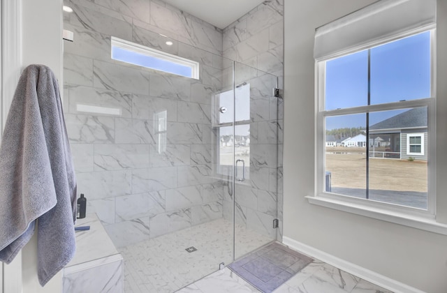 bathroom featuring a shower with shower door