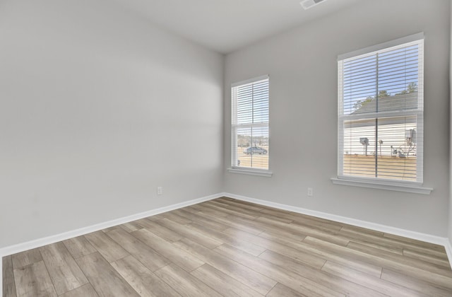 empty room with light hardwood / wood-style floors