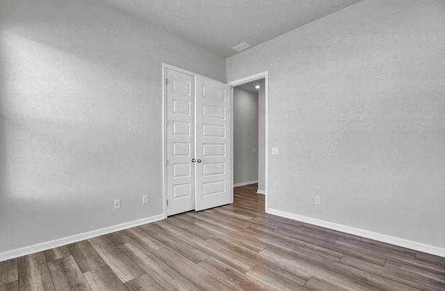 unfurnished bedroom featuring light wood-type flooring