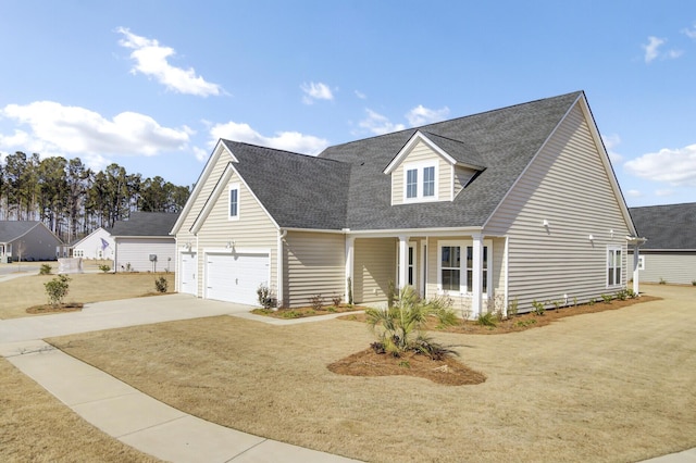 cape cod home with a garage, a porch, and a front yard