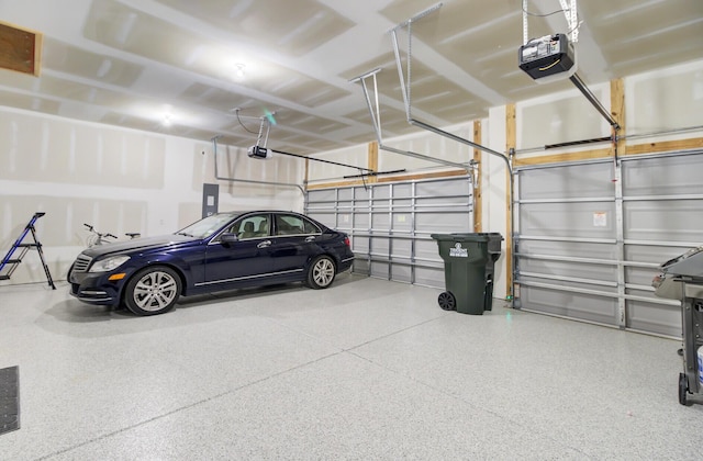 garage with a garage door opener and electric panel