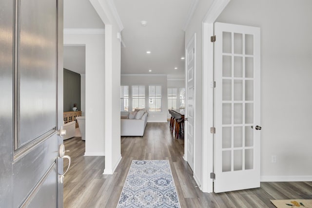 entryway featuring crown molding and light hardwood / wood-style floors