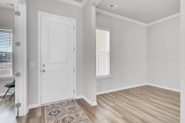 entrance foyer featuring light hardwood / wood-style flooring and ornamental molding