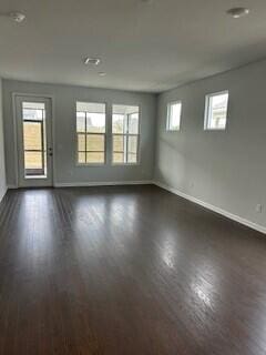 empty room featuring dark hardwood / wood-style flooring