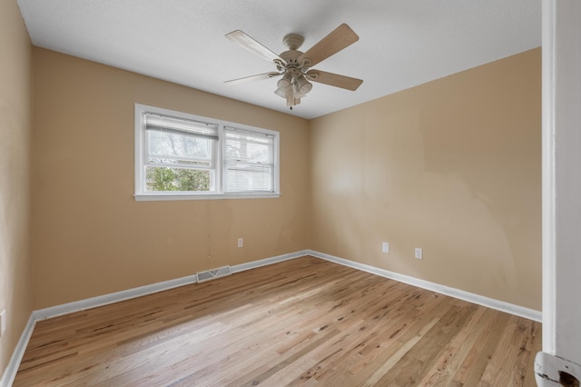 unfurnished room featuring light wood-type flooring and ceiling fan