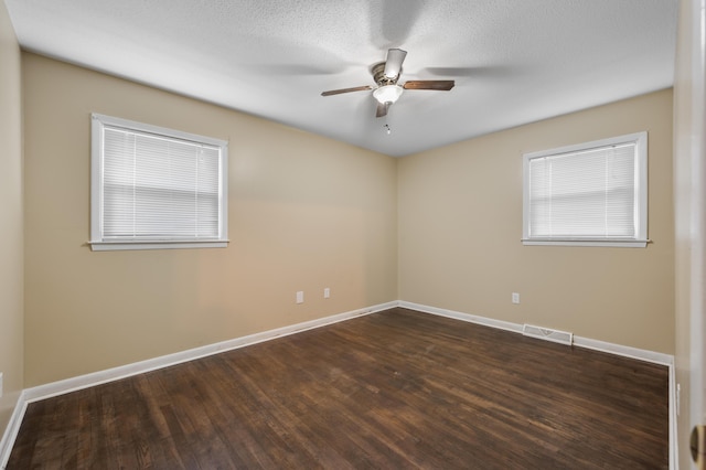 spare room featuring ceiling fan and dark wood-type flooring