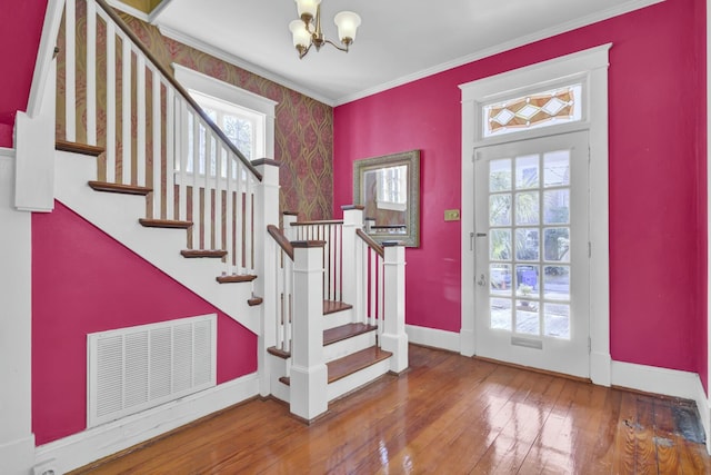 interior space featuring a chandelier, crown molding, and hardwood / wood-style floors