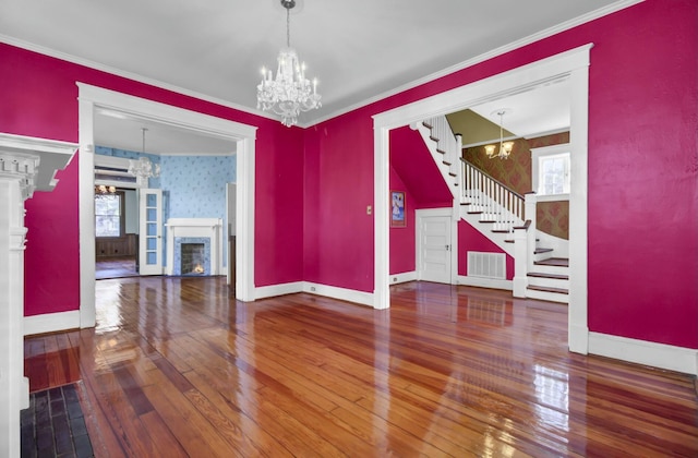 unfurnished dining area with hardwood / wood-style floors and a notable chandelier