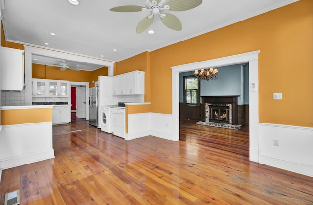 kitchen featuring white cabinets, ceiling fan, hardwood / wood-style floors, and stainless steel refrigerator with ice dispenser