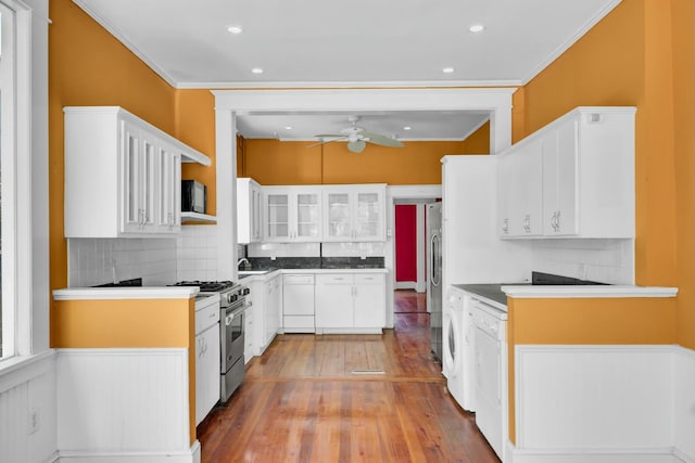 kitchen featuring white cabinetry, decorative backsplash, and stainless steel appliances