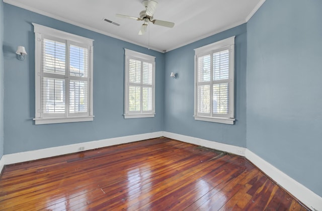 empty room featuring ceiling fan, crown molding, and dark hardwood / wood-style floors