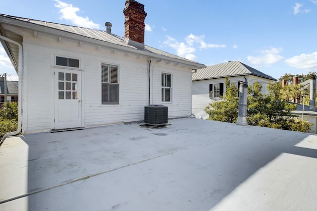 back of property with a patio area and central air condition unit