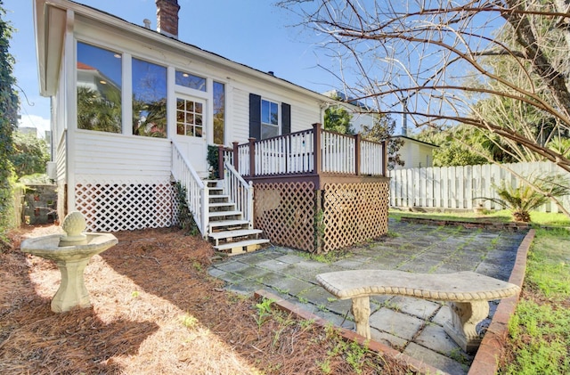 back of property with a wooden deck