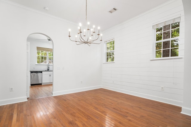 861 Center Park St, Charleston, SC 29492 - spare room with arched walkways, hardwood / wood-style flooring, ornamental molding, healthy amount of natural light, and a chandelier