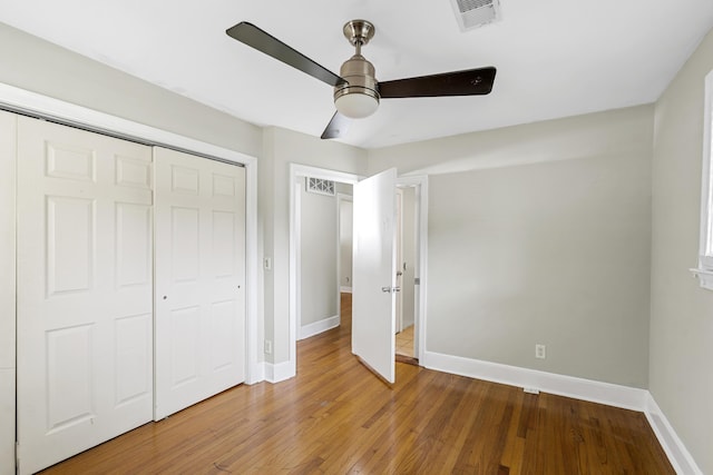 2404 Menola Ave, Charleston, SC 29414 - unfurnished bedroom with baseboards, hardwood / wood-style floors, a ceiling fan, and a closet