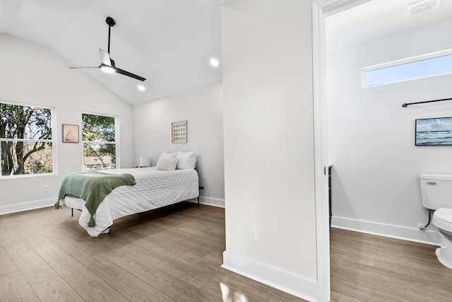 bedroom featuring multiple windows, hardwood / wood-style flooring, ceiling fan, and lofted ceiling