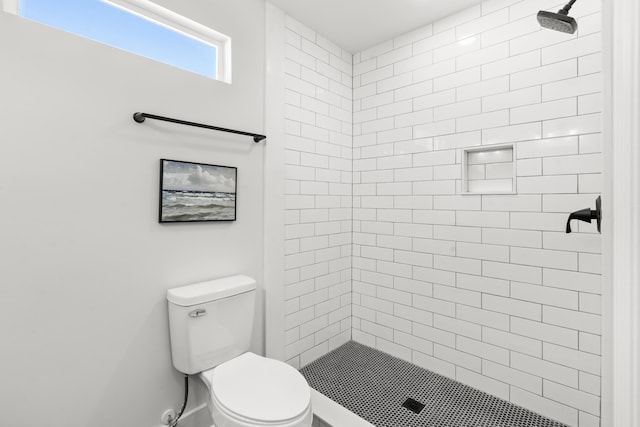 bathroom with toilet and tiled shower