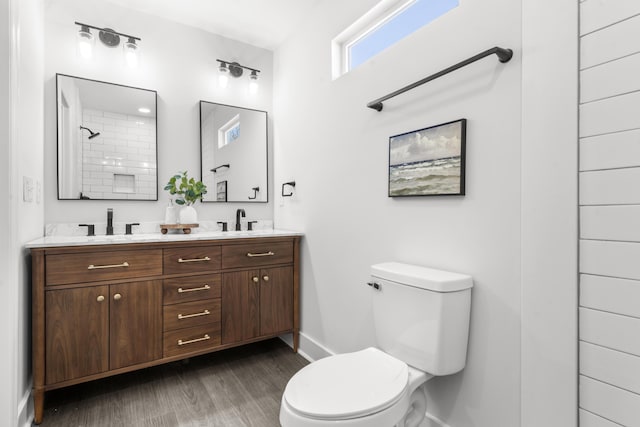 bathroom with hardwood / wood-style floors, vanity, and toilet