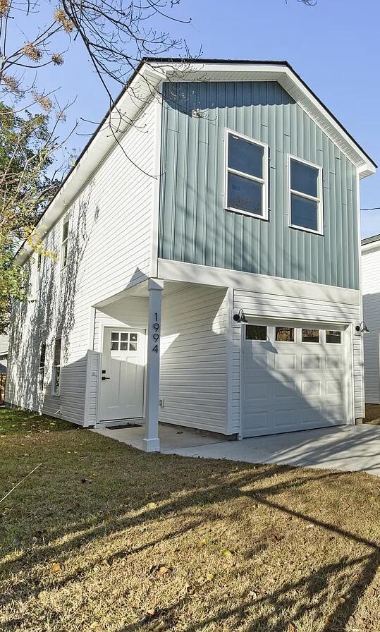 view of side of home with a garage and a yard