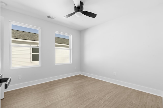 empty room featuring ceiling fan and light hardwood / wood-style flooring