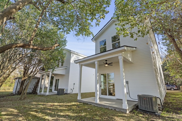 back of property with a lawn, ceiling fan, cooling unit, and a patio