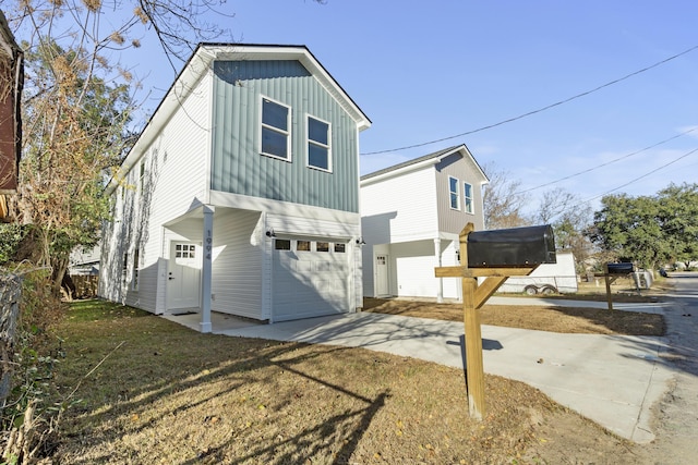 view of side of home featuring a yard and a garage