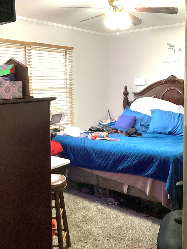 bedroom featuring ceiling fan, crown molding, and carpet flooring