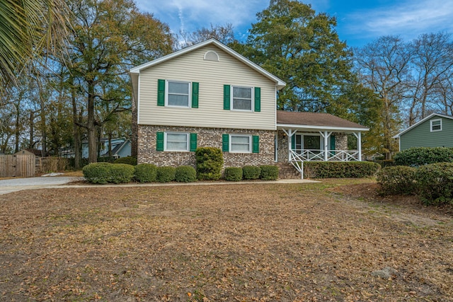 view of front of home with a front yard and a porch