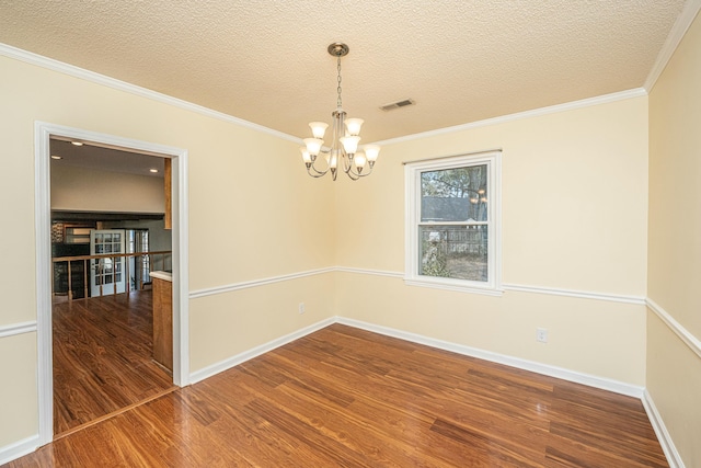 unfurnished room with hardwood / wood-style flooring, crown molding, a notable chandelier, and a textured ceiling