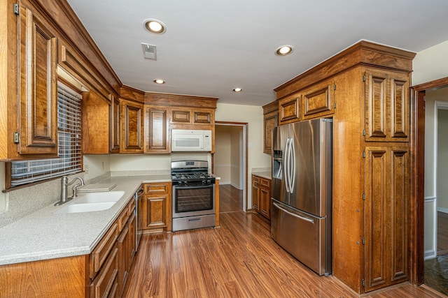 kitchen featuring appliances with stainless steel finishes, dark hardwood / wood-style floors, and sink