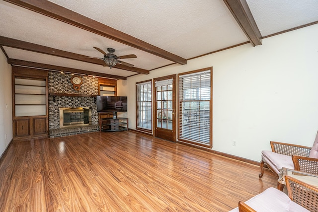 unfurnished living room with wood-type flooring, a fireplace, and a textured ceiling