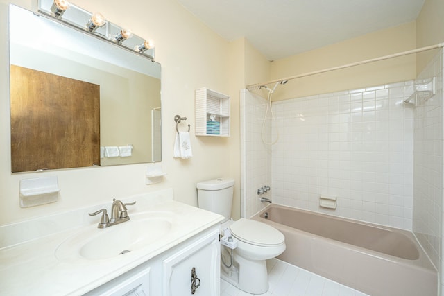 full bathroom featuring tiled shower / bath, vanity, and toilet