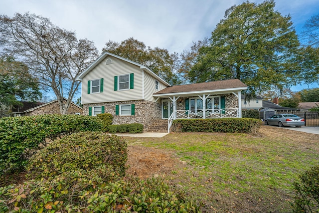 split level home featuring a porch and a front yard