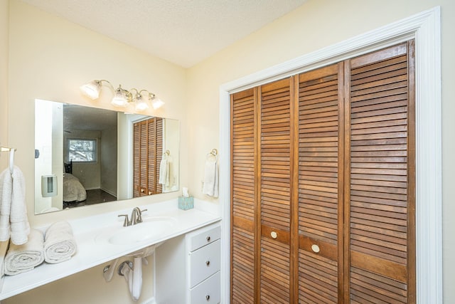 bathroom featuring sink and a textured ceiling