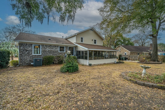 back of property featuring central AC unit and a sunroom