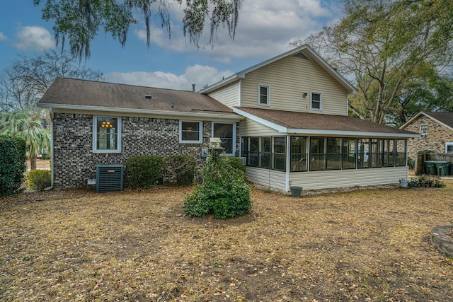 back of house with central AC unit and a sunroom