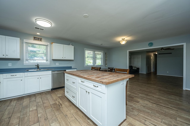 565 Estates Dr, Walterboro, SC 29488 - kitchen with butcher block counters, dishwasher, light wood finished floors, and white cabinetry