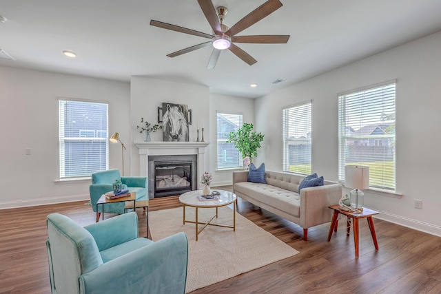 175 Darby Meadow Ln, Ridgeville, SC 29472 - living area with a glass covered fireplace, baseboards, wood finished floors, ceiling fan, and recessed lighting
