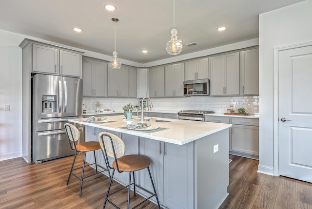 175 Darby Meadow Ln, Ridgeville, SC 29472 - kitchen with appliances with stainless steel finishes, gray cabinets, dark wood-style flooring, tasteful backsplash, and recessed lighting