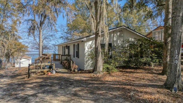 view of side of home with a wooden deck